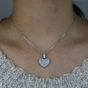 Close-up of heart-shaped pendant necklace with cubic zirconia on a female model
