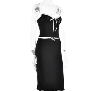 Detailed close-up of black two-piece set with white lace trim and ribbon bow accents
