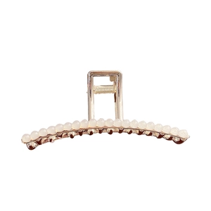 Elegant gold metal hair claw clip featuring a row of white pearls for sophisticated styling