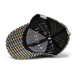 Detail view of colorful houndstooth baseball cap interior with sweatband and stitching