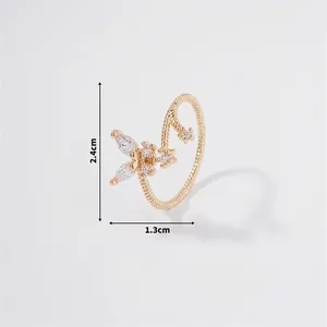 Detail view of gold butterfly ring with marquis zircon and rope texture band