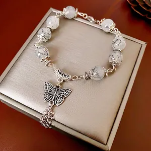 Bracelet en perles de verre papillon avec pompons et perles à texture marbrée vintage