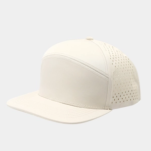 Detail view of laser-perforated side panels on beige 7-panel flat brim baseball cap