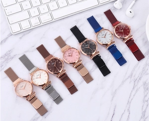 Collection of women's Milanese quartz watches in eight colors on a marble surface