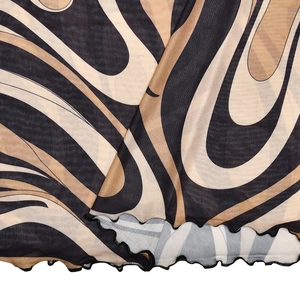 Close-up of semi-transparent mesh fabric with abstract black and khaki swirl print