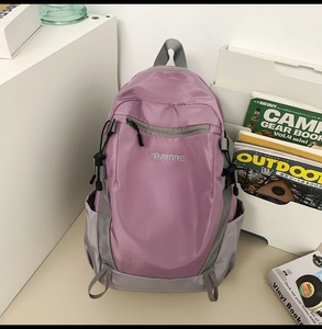 Close-up of durable purple and grey nylon backpack with side pockets and front logo