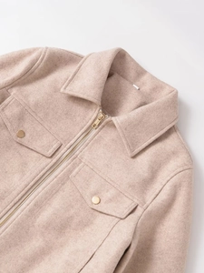 Detail of light beige zip jacket showing wool texture and metallic snap pockets