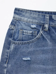 Detailed close-up showing distressed denim texture and stitching on light blue shorts