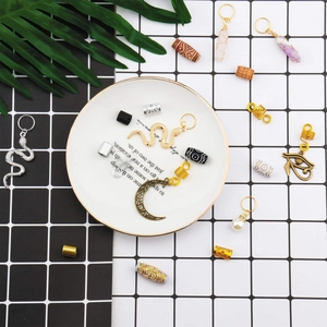 Flat lay of 121pcs boho hair accessories with gold charms and wood beads on white ceramic plate