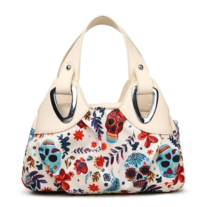 Women's minimalist tote bag featuring colorful sugar skull and floral patterns with cream handles