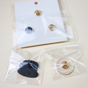 Detail of metal butterfly clutch and black rubber pin backs for creative enamel brooches