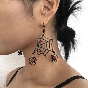 Detail of spider web tassel earring with red rhinestones and black spider charms