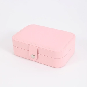 Portable pink leather jewelry box with rectangular snap closure for rings and earrings