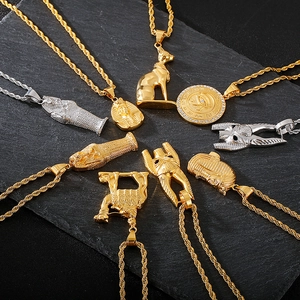 Detailed flat lay of gold and silver Egyptian pendants on a textured slate background