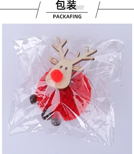 Detailed close-up of handmade wooden reindeer ornament with red pom-pom and hanging beads
