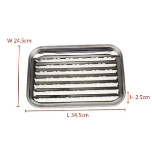 Detail view of perforated stainless steel grill pan with dimensions 34.5x24.5x2.5 cm