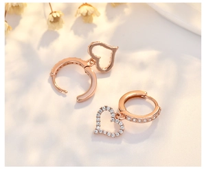 Detailed macro view of rose gold heart earrings with sparkling cubic zirconia pavé setting