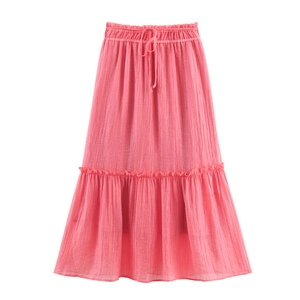 Detail of pink bohemian tiered maxi skirt featuring pleated texture and drawstring waist
