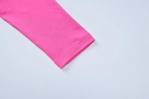 Macro shot of rose pink knitted sleeve cuff with precise double-needle stitching detail