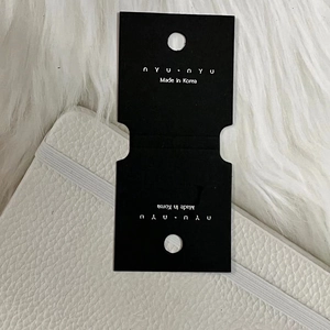 Detail of premium black jewelry backing card with nyu nyu logo and Korean origin text