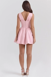 Rear view of a pink mini dress featuring a deep V-back design and high waist fit