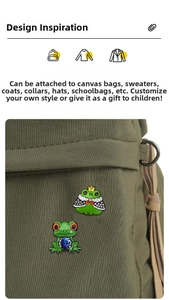 Detailed view of cartoon frog pins with rhinestones on a green canvas bag