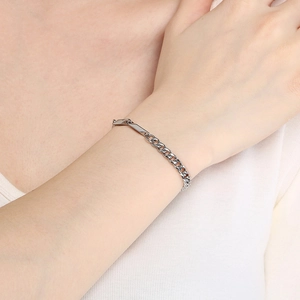 Close-up of minimalist silver Cuban chain bracelet with a polished rectangular metal plate