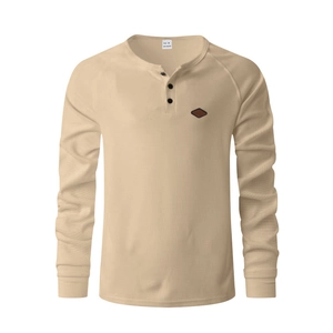 Detail of waffle knit fabric and three-button Henley collar on a men's raglan shirt