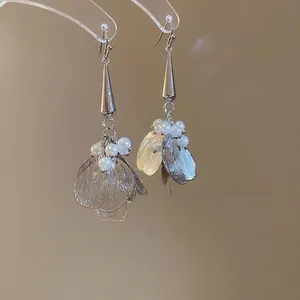 Elegant silver tassel earrings with hollow petals and white pearls on a hook