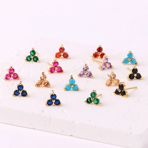 Multi-color zircon cluster stud earrings display on stone base with golden finish