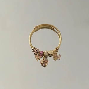 Gold cable wire bracelet with pink enamel butterfly and crystal heart charms