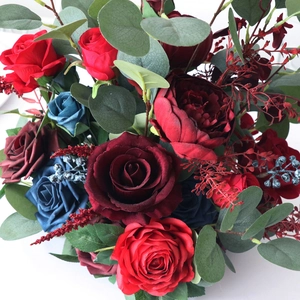 Artificial red and navy roses with eucalyptus foliage for wedding centerpiece