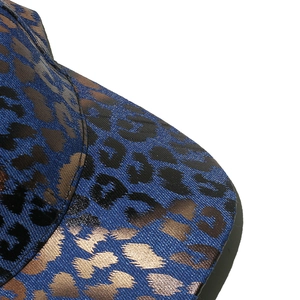 Close-up of gold foil leopard print on navy fabric showing detailed metallic texture