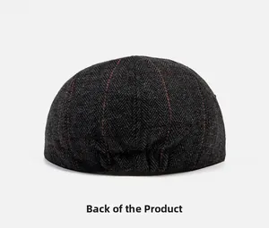 Rear view of dark grey herringbone newsboy cap showing pleated fabric detail and red stripes