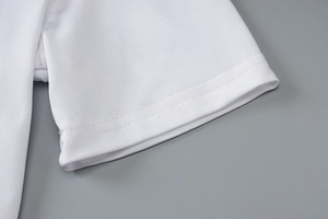 Detail view of white short-sleeve yoga jumpsuit cuff with mesh fabric texture