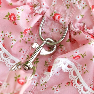 Detail of pink floral pet harness featuring silver metal buckle and white lace trim