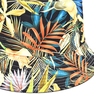 Detailed view of tropical leaf print and reinforced stitching on the brim of a bucket hat