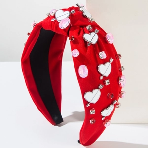 Close-up of red knotted headband with rhinestone hearts and Cupid arrow charms