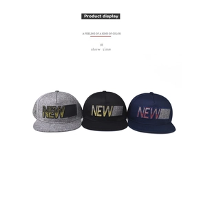 Detailed view of three flat brim baseball caps in grey, black, and navy with NEW embroidery