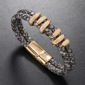 Close-up of woven leather bracelet with gold magnetic clasp and diamond-encrusted accents