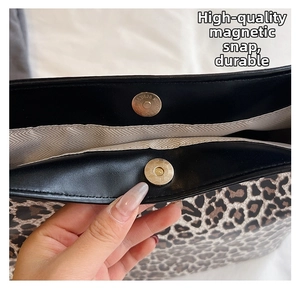 Detail showing high-quality dual magnetic snap closures on leopard print tote bag