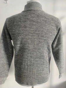 Close-up of gray knitted sweater showing premium texture and ribbed hem detail on a mannequin
