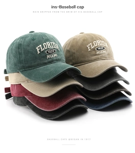 Close-up of vintage embroidered baseball caps in multiple colors stacked on white background