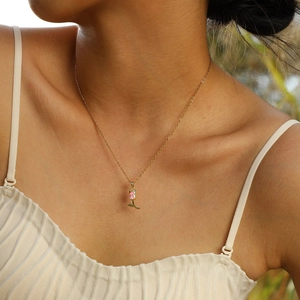 Close-up of a pink tulip pendant necklace with zircon inlay on a female model