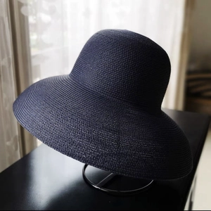 Detail showing the tight weave texture of the navy blue wide brim straw sun hat