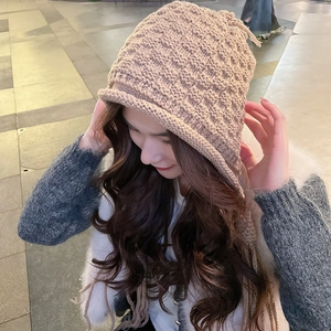 Detail of khaki chunky knit hood with braided drawstrings and rolled edge texture