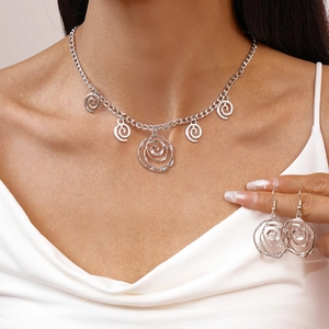 Detail of silver hollow rose petal necklace and matching hook earrings on a model