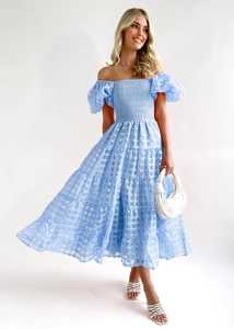 Detail of light blue off-shoulder smocked dress with sheer checkered textured fabric