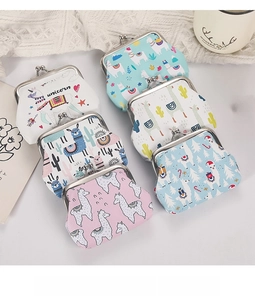 Flat lay of vintage metal clasp coin purses with alpaca and unicorn prints and floral decor