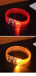 Detail showing glowing LED bracelet in red and orange colors with bubble plastic texture